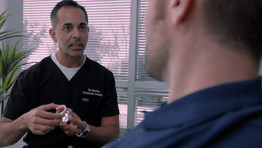 dr-showing-implants-to-player